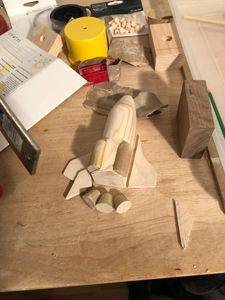 Wooden pieces being assembled into space shuttle